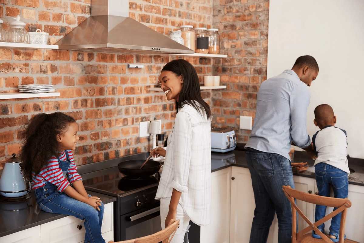 A family preparing a meal together, with Airis protecting the kitchen